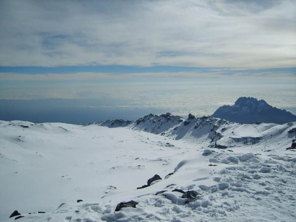 the volcanic rim covered in snow and ice of kilimanjaro