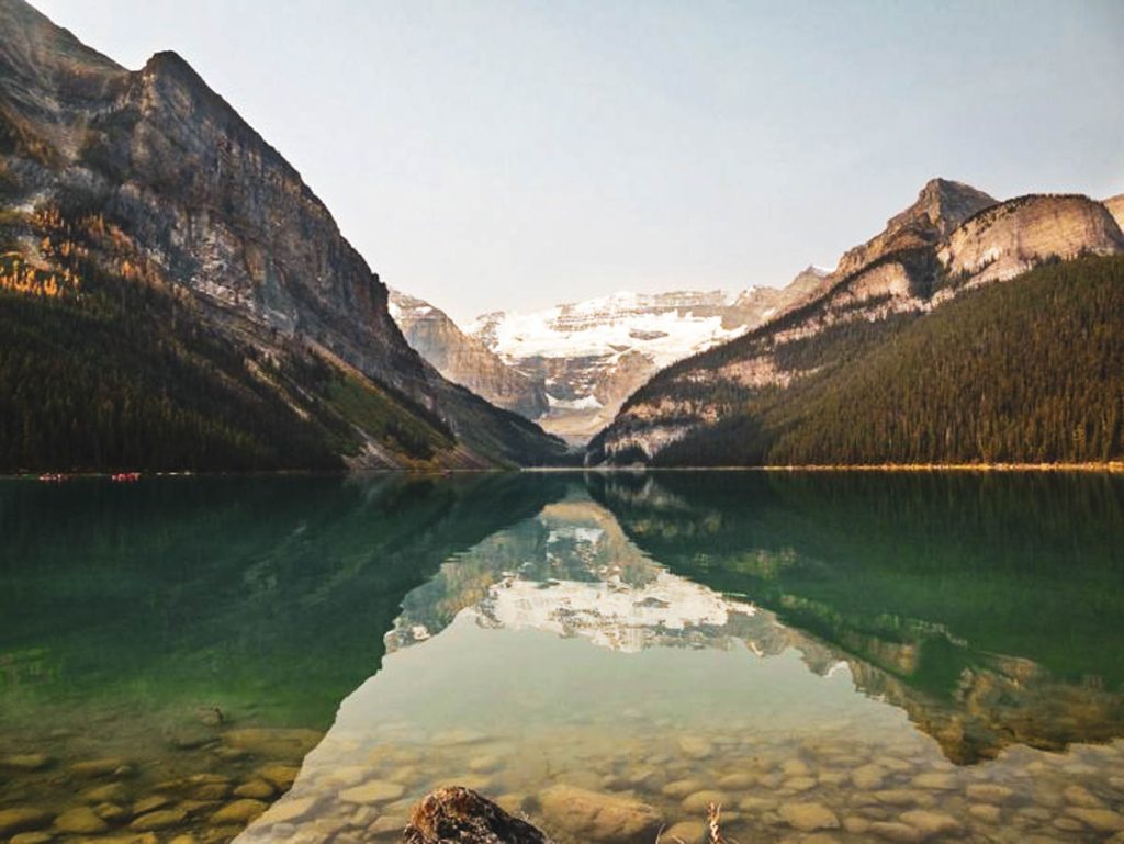 looking down lake louise with mountains and reflections