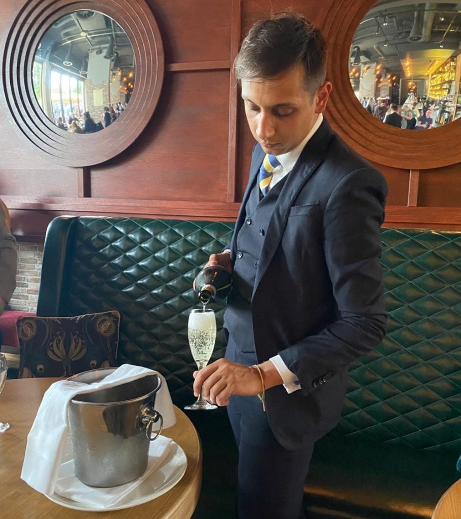 waiter pouring the fizz