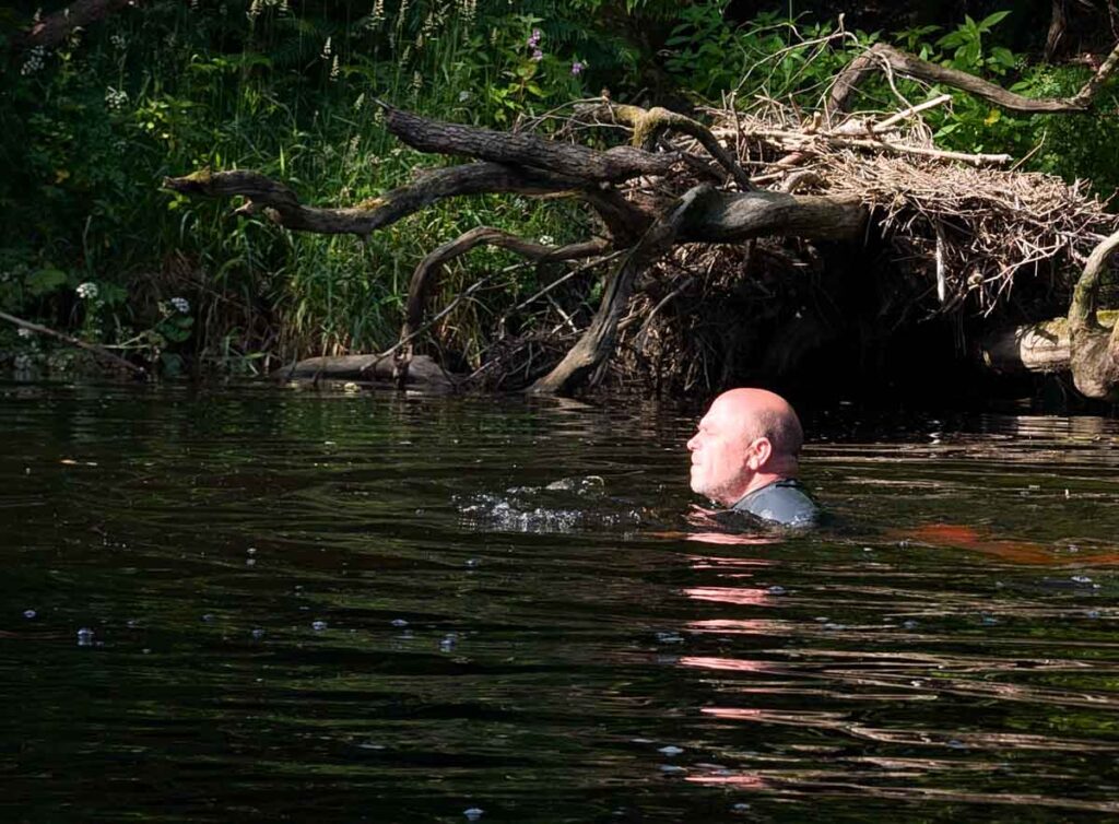 paul steele the baldhiker swimming in a river