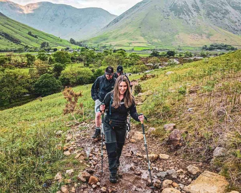 hiker using trekking poles on a mountain climb