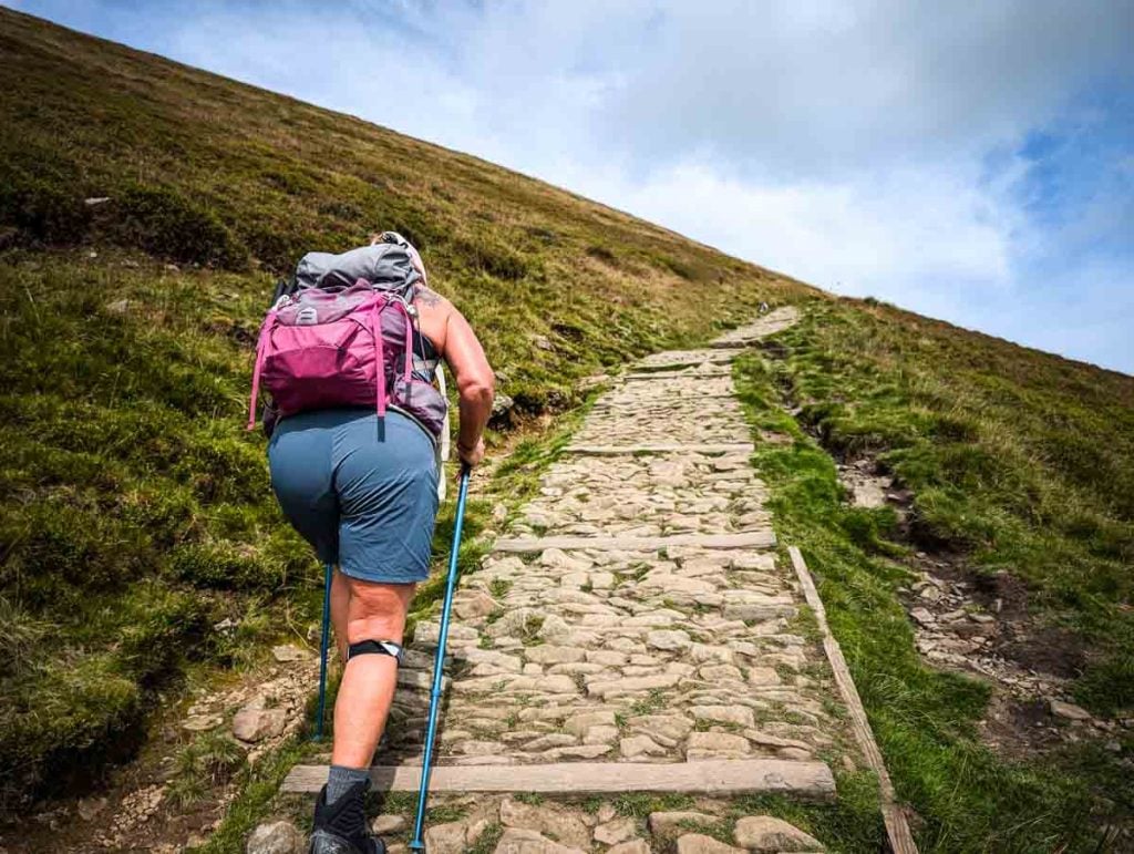woman climbing a hill