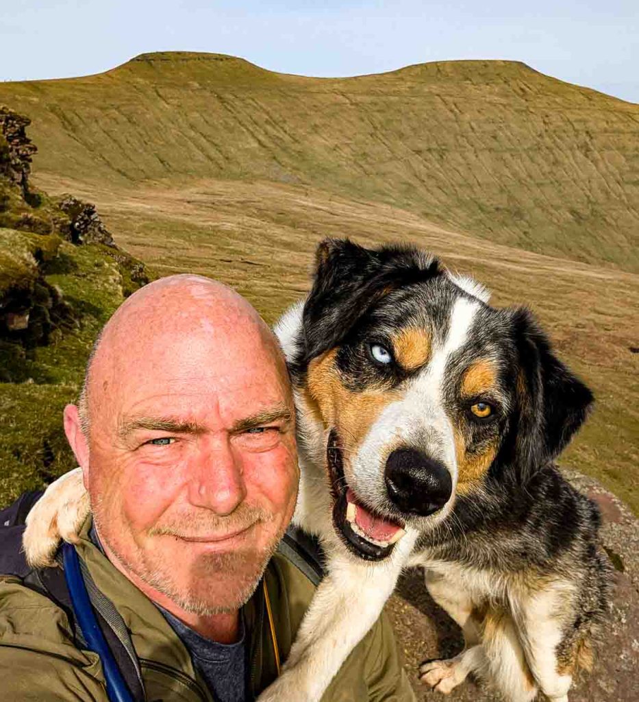 Paul Steele and his dog with Pen y Fan in background