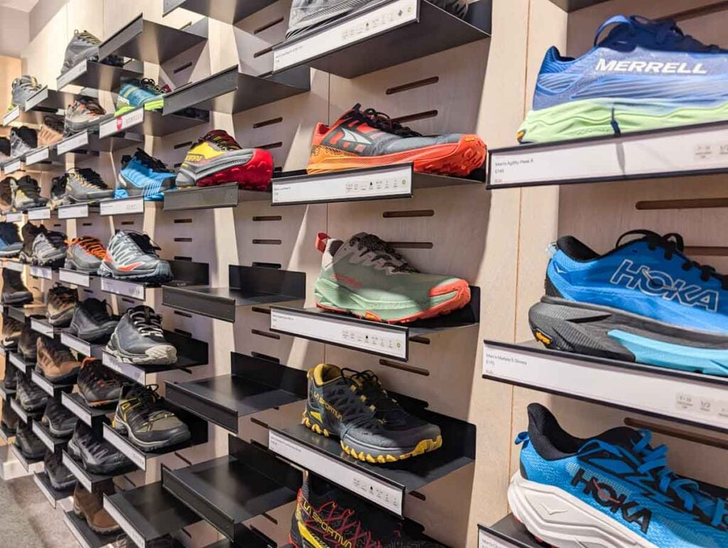 wall of walking shoes at ellis brigham