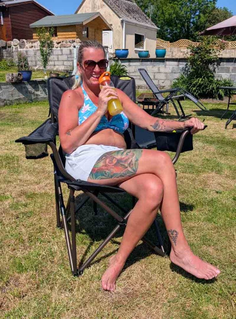 having a drink in the zempire shermanator camping chair