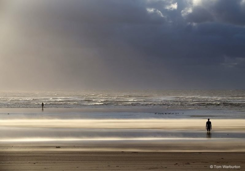 The figures of Another Place on Crosby Beach