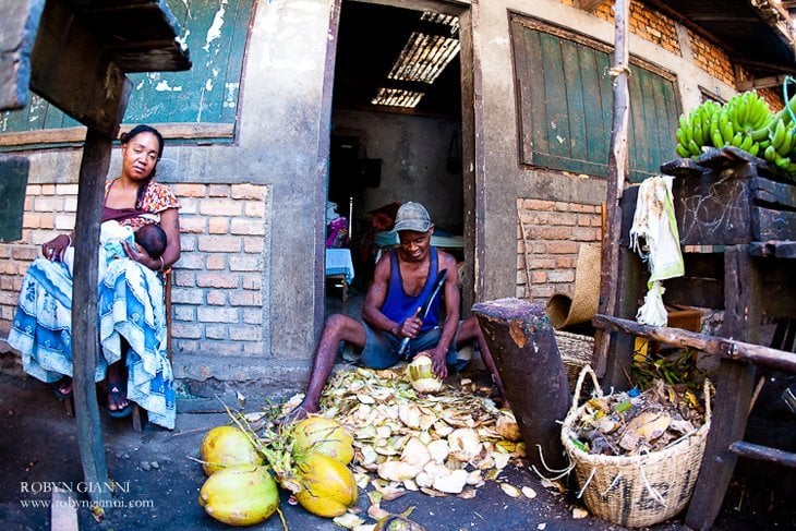 Peeling coconuts at the roadside markets.