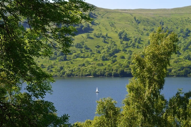 boat on ullswater viewed through the trees