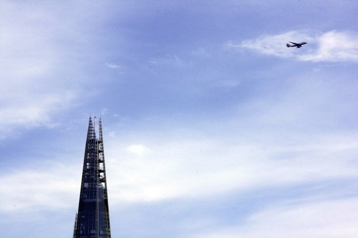 Plane flying past the top of the Shard