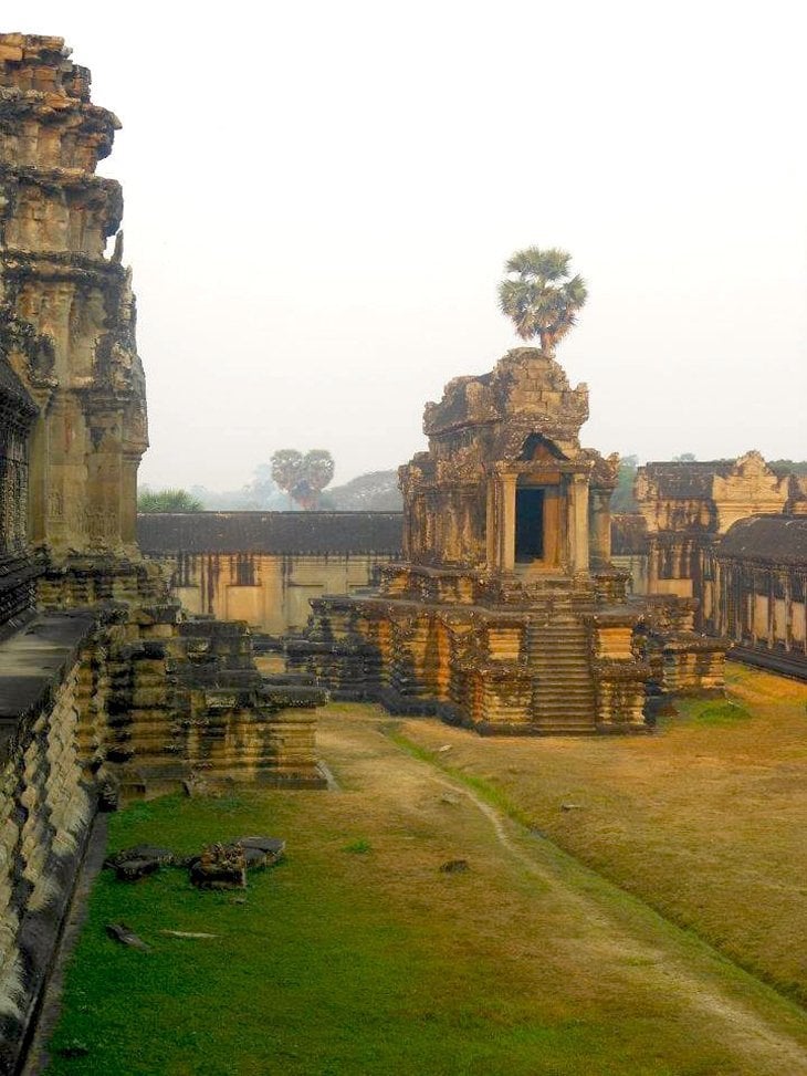 Ornate carvings fleet across stone at an Angkor Wat temple